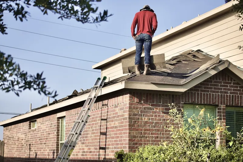 Professional roofer working on a residential roof in Pancake
